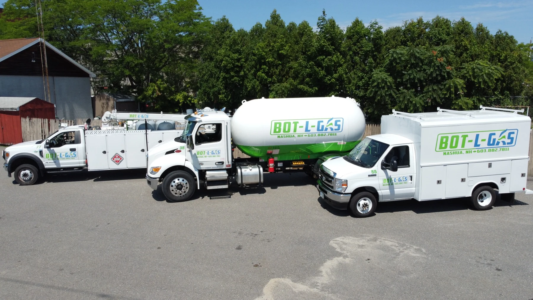 Bot-L-Gas propane delivery truck and two service trucks with green and blue company branding